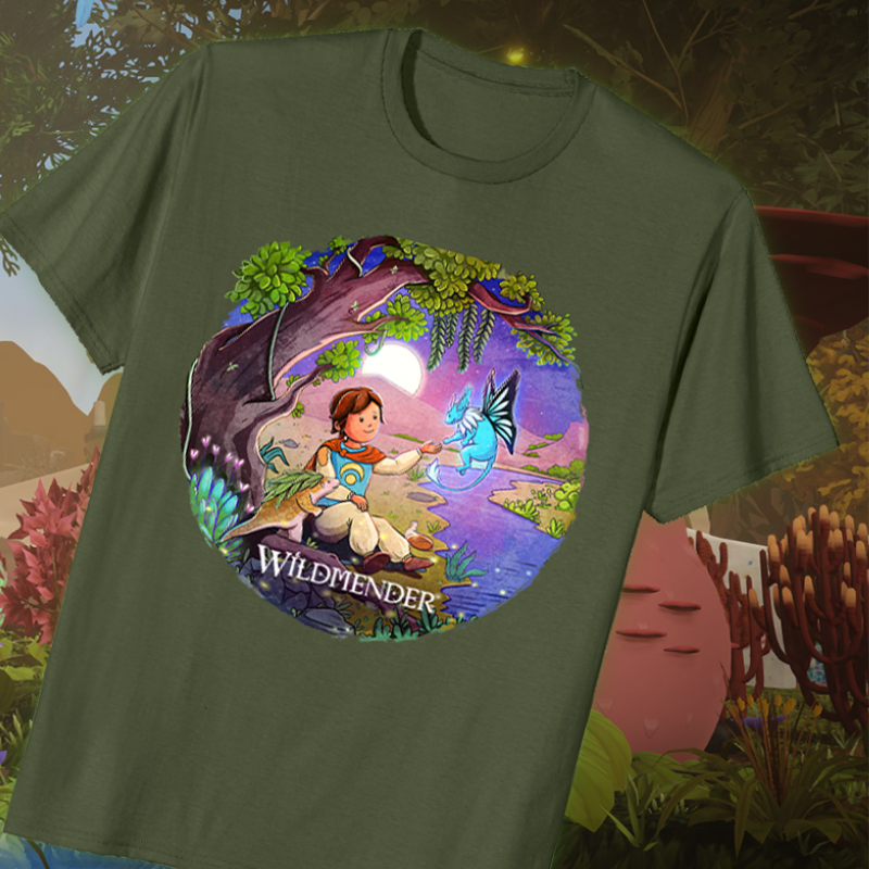 Wildmender merchandise. Image shows a green tshirt. On the tshirt is a circle with a graphic of the Wildmender game scene and the main character sitting next to a stream, looking up at a friendly spirit. 